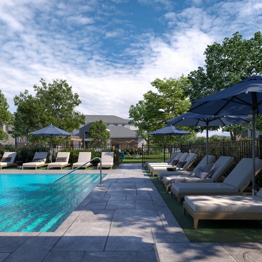 a pool with lounge chairs and umbrellas by it