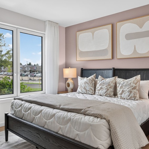 a bedroom with a bed and two nightstands