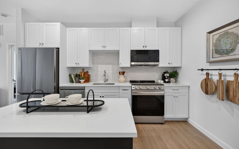 a kitchen with white cabinets