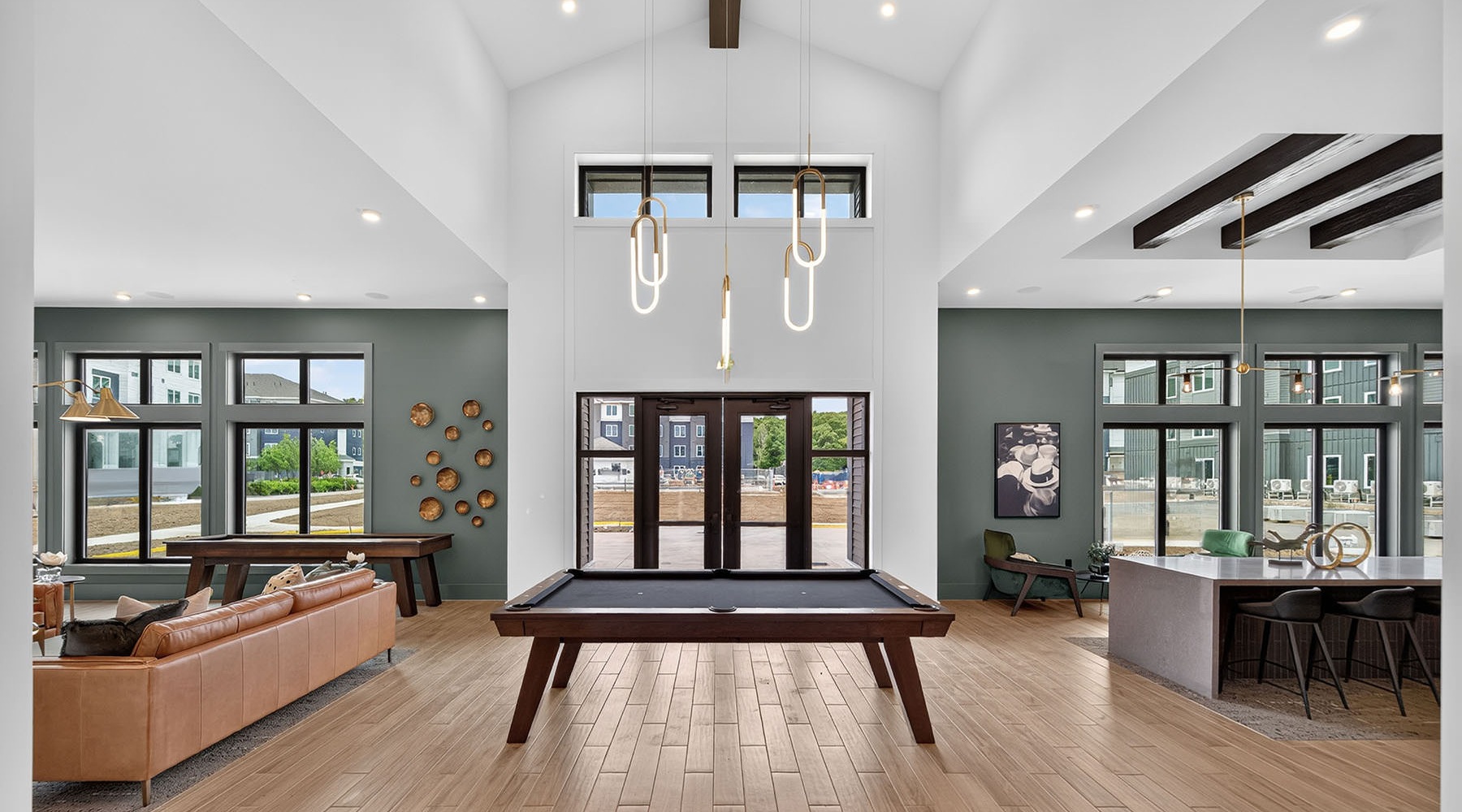 a clubroom with a pool table, couch and tables