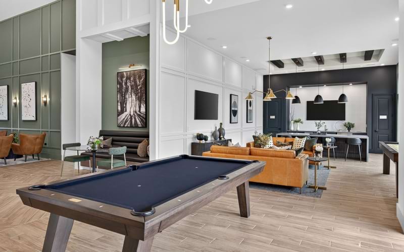 a clubroom with a pool table and a couch