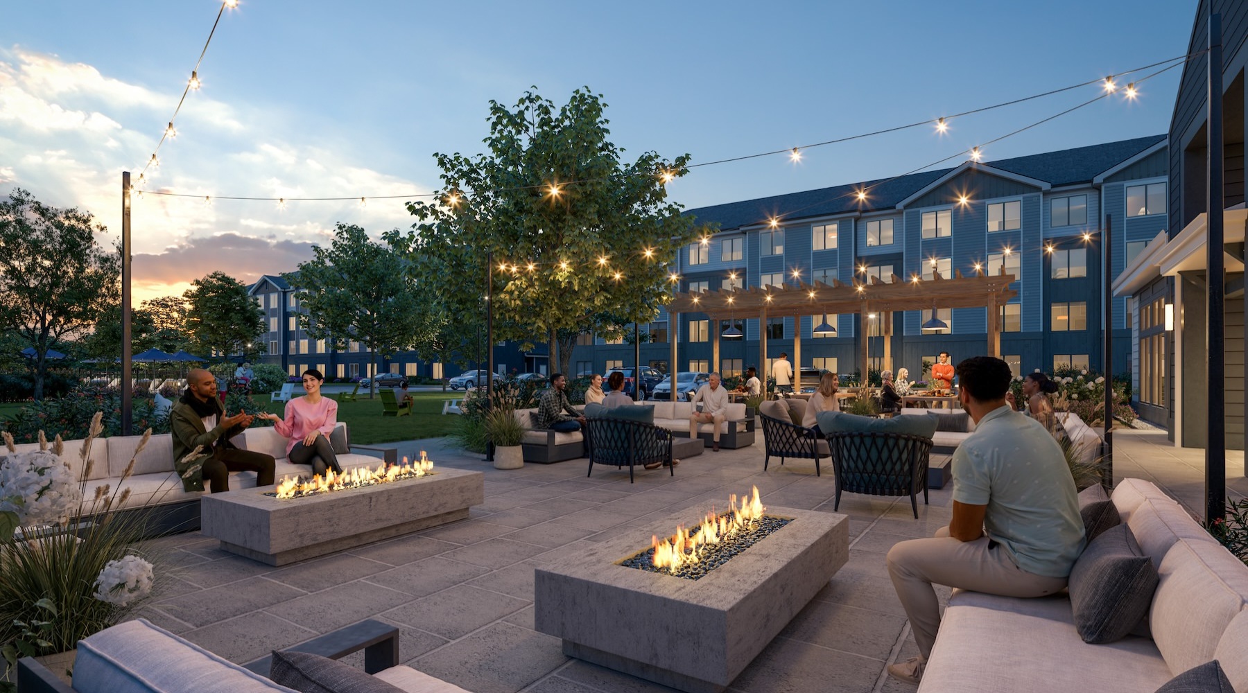 a courtyard with people, couches and fire pits