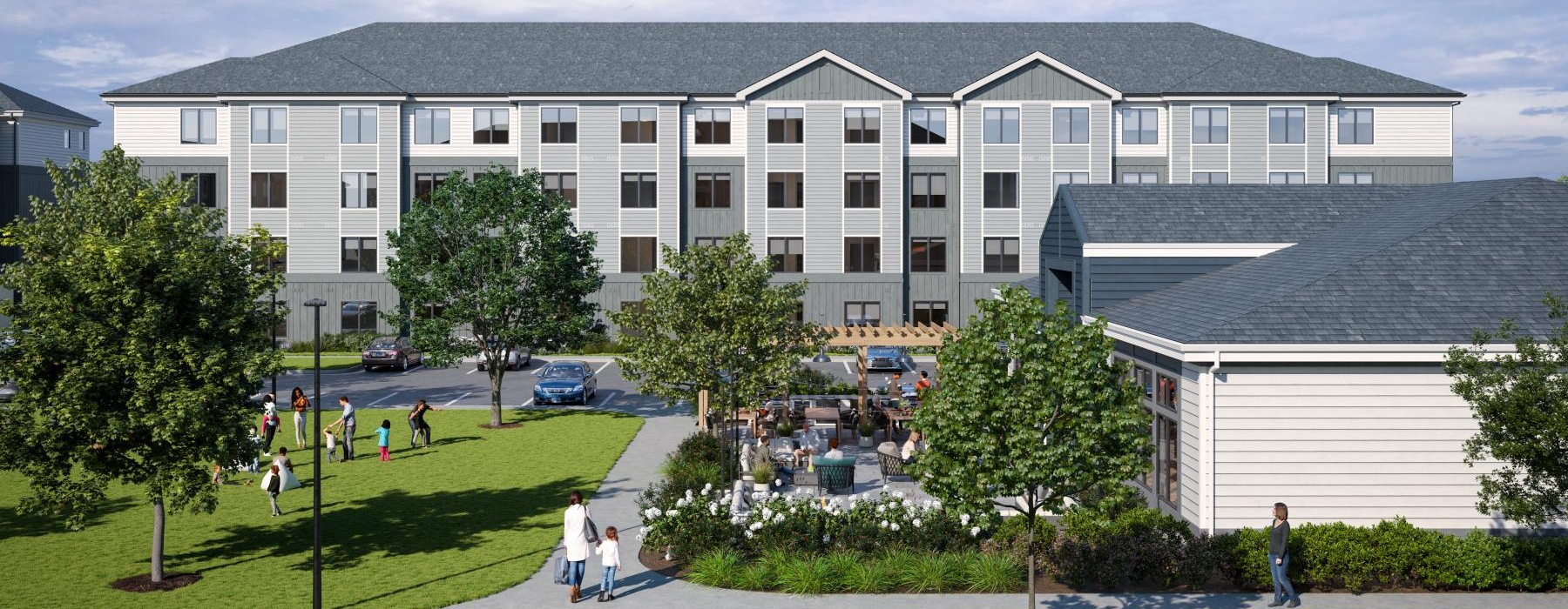 a large building with a lawn and trees in front of it