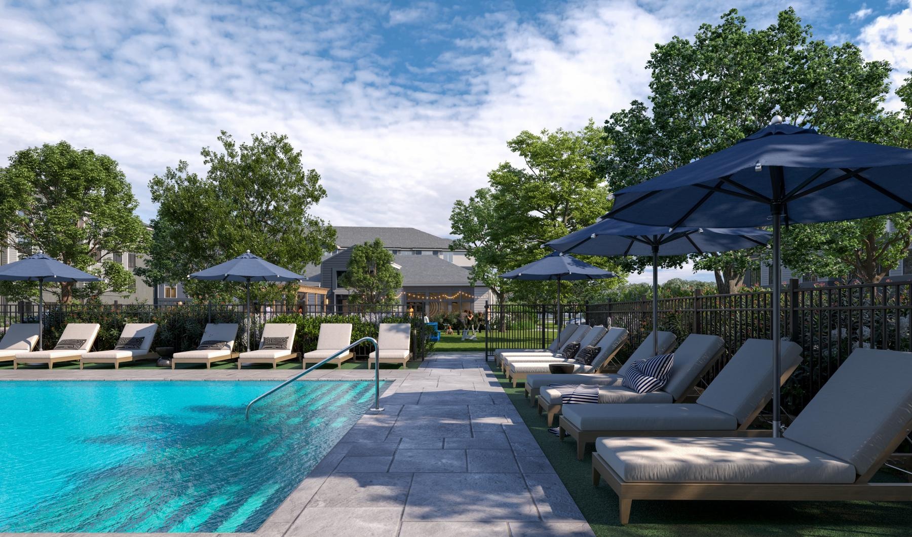a pool with lounge chairs and umbrellas by it